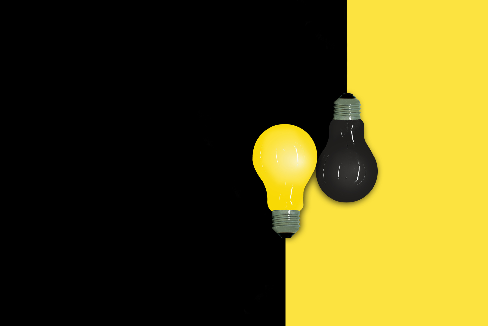 Yellow and Black light bulb put on half yellow and black background.